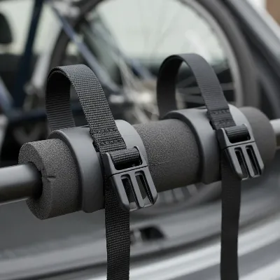 Close-up view of a trunk bike rack's bike cradles and nylon securing straps, highlighting features for bike protection and attachment stability during transport.