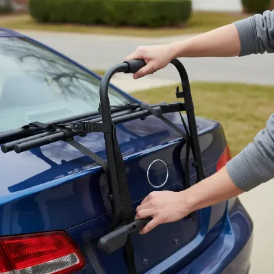 Person performing final stability check on trunk bike rack